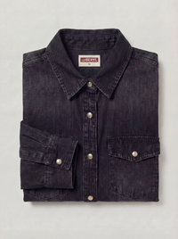 Folded dark denim shirt with visible brand label on a light gray background